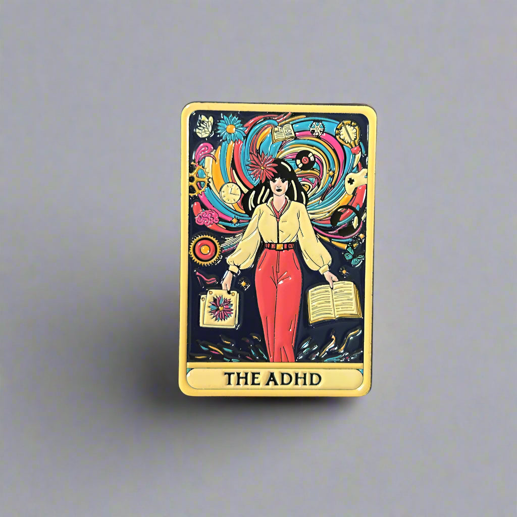 Card with 'The ADHD' design held by a hand on a wooden surface