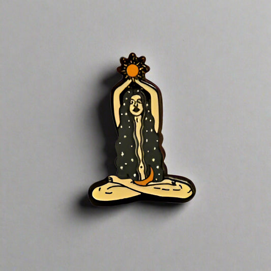 Hand holding a small decorative item on a gray surface