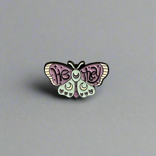 Butterfly-shaped pin with 'Heidi' text on a beige background