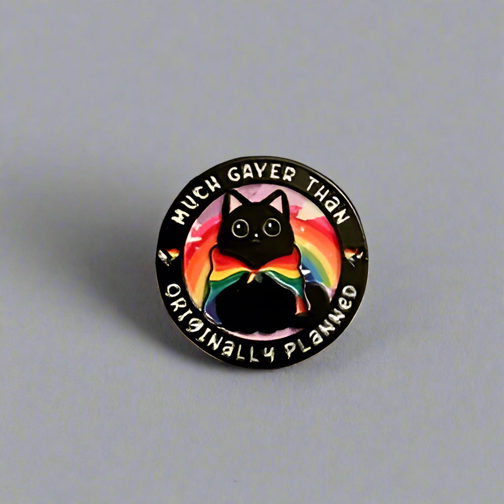 Round sticker with a rainbow cat design on a gray surface