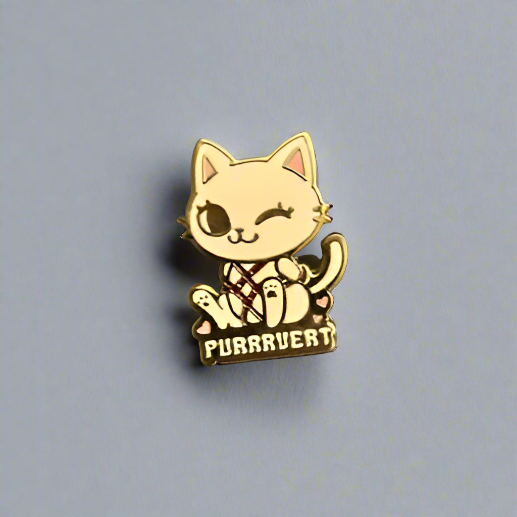 Gold cat-shaped pin with 'PUURRVEY' text on a gray surface