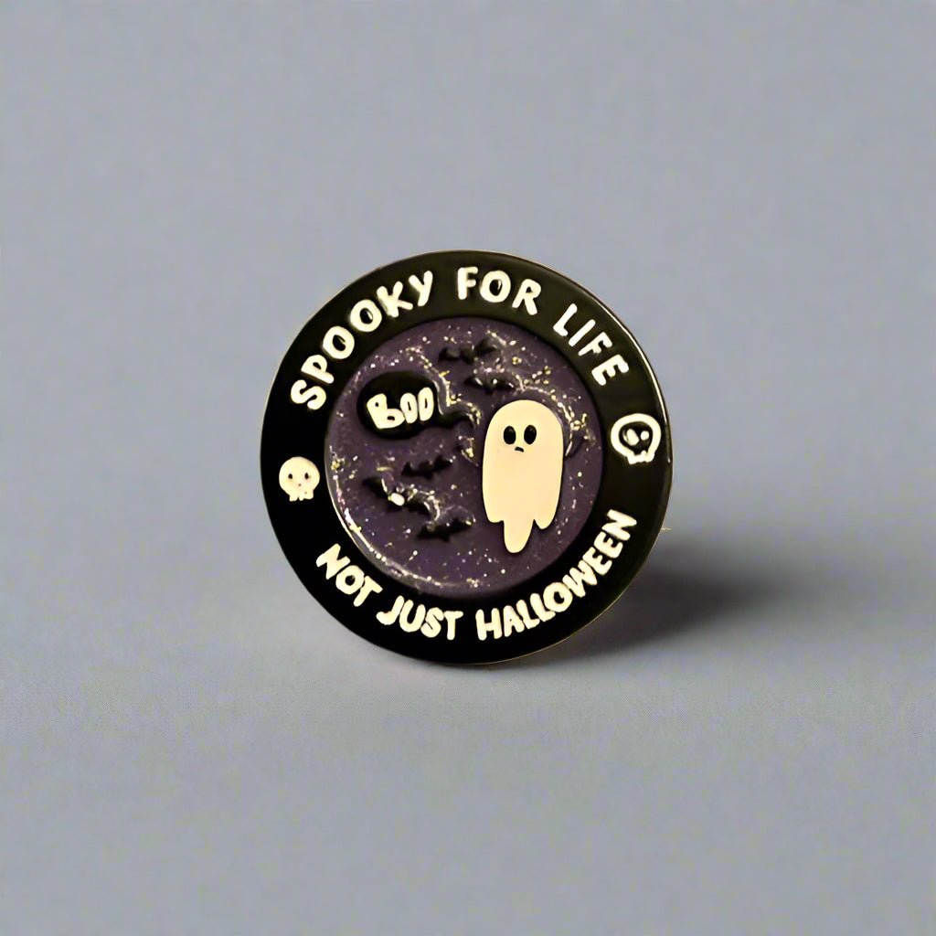 Halloween-themed button badge with ghost and text on a gray background