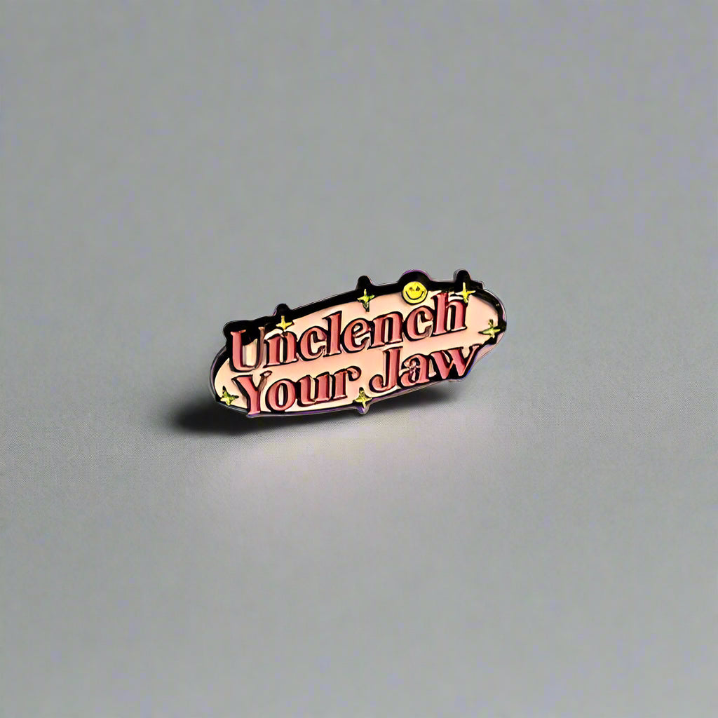 Small metallic badge with text on a plain background