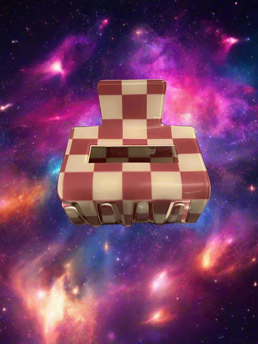 Red and white checkered object with 'Marilyn' on a gray surface
